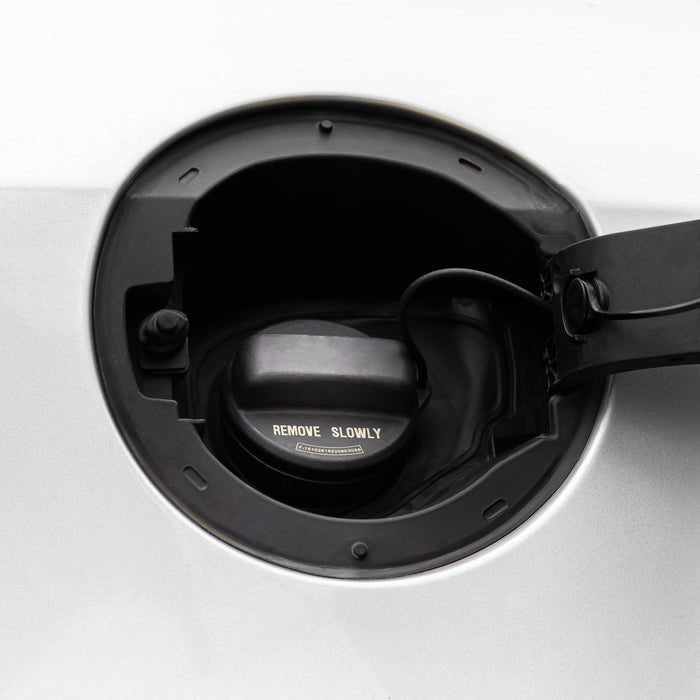 Close-up of a Honda Fuel Tank Gas Cap 17670-T3W-A01, with the fuel cap visible inside and the flap partially open.