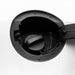 Close-up of a black fuel door cover opened to reveal the fuel filler cap inside a white vehicle body.