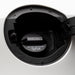Close-up of a black Toyota 77310-12140 Fuel Cap opening inside a silver vehicle trunk, with printed warning text on the cap.