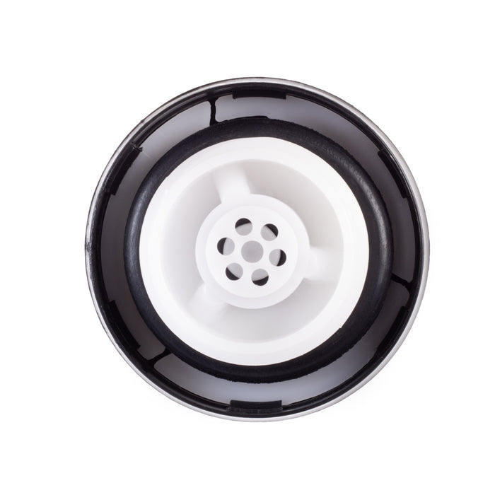 A top-down view of a Toyota 77310-12140 Fuel Cap, featuring a white plastic center with multiple drainage holes, surrounded by a black rubber gasket and a silver metal rim, isolated on a white background.