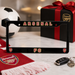 Arsenal FC license plate frame with soccer ball, gift box, and scarf on a table.
