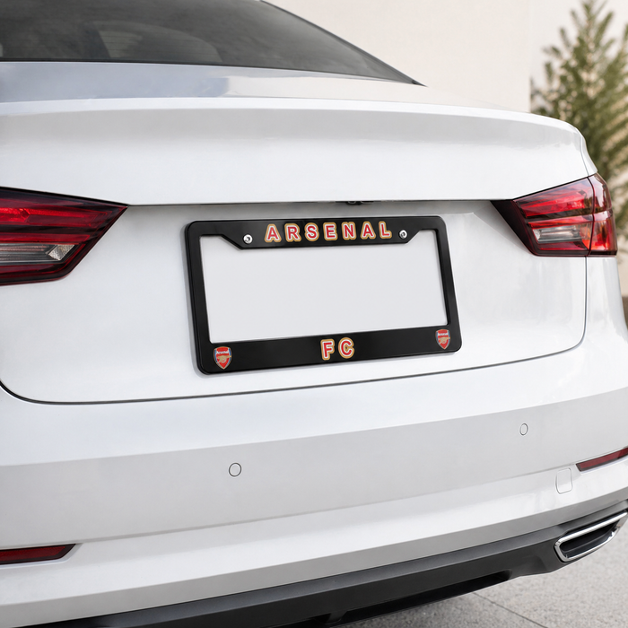 Car license plate frame with 'Arsenal FC' branding on a white car.