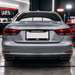 Back view of a silver car in a garage setting