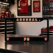 Black Arsenal FC license plate frame on a workbench with tools and sports memorabilia in the background.