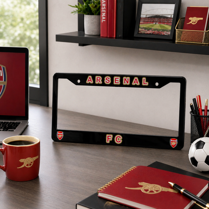 Arsenal FC license plate frame on a desk with office supplies and Arsenal branding.