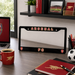 Arsenal FC license plate frame on a desk with office supplies and Arsenal branding.