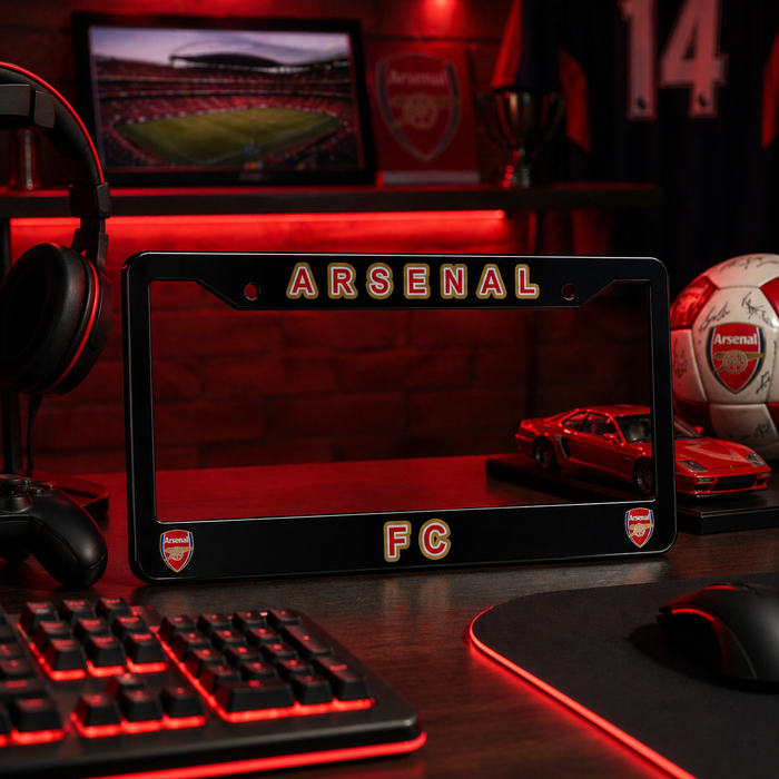 Arsenal FC-themed desk setup with laptop, keyboard, and sports ball.