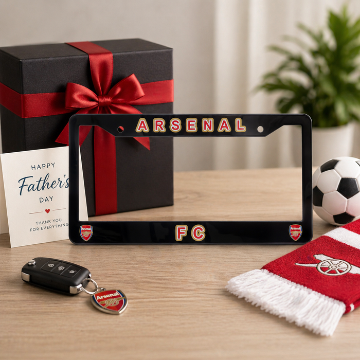 Gift set with Arsenal FC license plate frame, keychain, and scarf on a table.