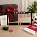 Gift set with Arsenal FC license plate frame, keychain, and scarf on a table.