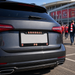 Car with Arsenal FC license plate in front of a stadium
