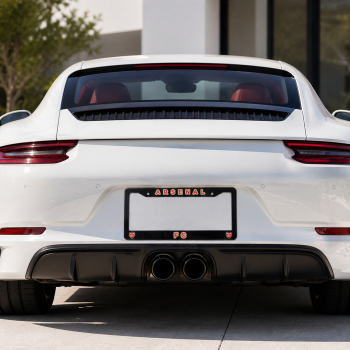 White car with a visible 'Arsenal' license plate holder on a blurred background