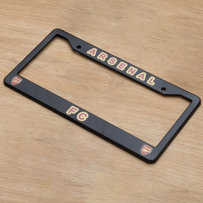 Black Arsenal FC license plate frame on a wooden surface