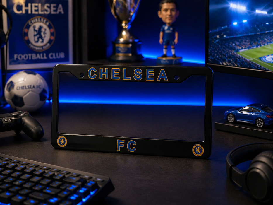 Chelsea FC merchandise including a phone case, bobblehead, and soccer ball on a desk.