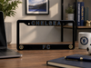 Chelsea FC license plate frame on a desk with laptop, mug, and books in the background