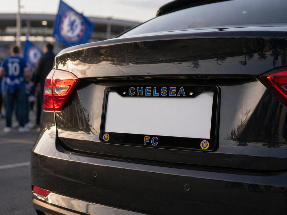 Car with a Chelsea FC license plate in an outdoor setting with people and flags in the background.