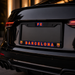 Car license plate with 'FC Barcelona' text and logo on a dark background