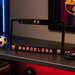 Black license plate frame with 'FC Barcelona' text on a dark surface.
