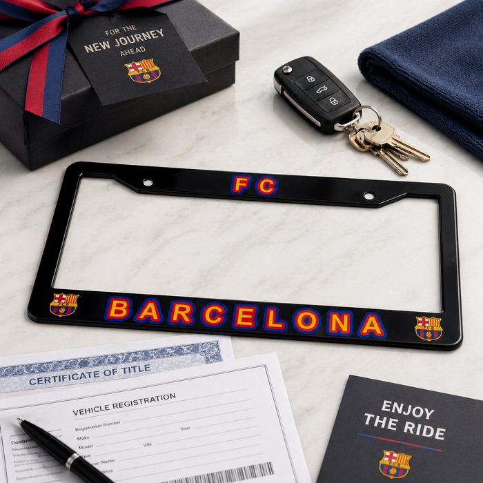 Barcelona license plate frame with keys, gift box, and documents on a marble surface