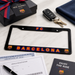 Barcelona license plate frame with keys, gift box, and documents on a marble surface