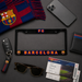 A black license plate frame with 'FC BARCELONA' in red and blue lettering, surrounded by FC Barcelona-themed accessories on a dark gray background, including a scarf, sunglasses, tickets, a phone, a key fob, and a wallet.