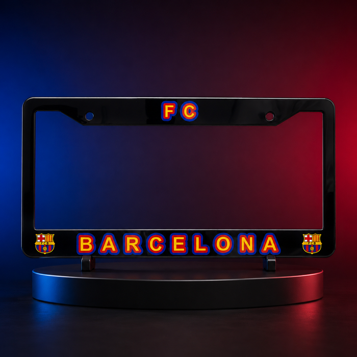 A black license plate frame featuring 'FC BARCELONA' in glowing red and blue lettering, displayed on a circular stand against a blue-to-red gradient studio background.