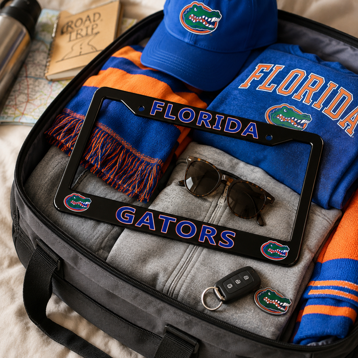 Florida Gators themed travel accessories packed inside a black duffel bag, including a blue cap, a blue and orange scarf, a blue sweatshirt, a gray zip-up hoodie, sunglasses, a key fob, and a black license plate frame with Florida and Gators graphics.