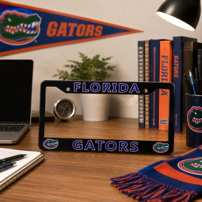 A black Florida Gators license plate frame displayed on a wooden desk, surrounded by themed Florida Gators decor including a banner, scarf, and books.