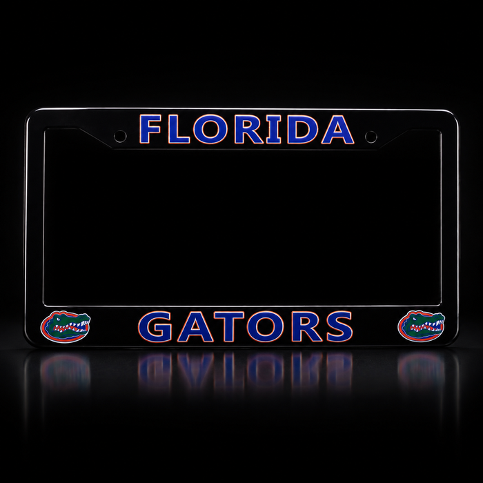 A black license plate frame featuring 'FLORIDA' at the top and 'GATORS' at the bottom in blue outlined lettering, with Florida Gators logo graphics on the lower corners, shown on a reflective black background.
