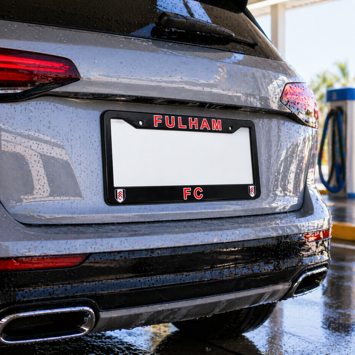 Car with a 'Fulham FC' license plate in a garage.