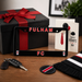 Fulham FC merchandise including a license plate frame, keychain, and card on a wooden surface.