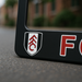 Close-up Fulham FC logo showcased on license plate frame