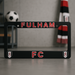 Black license plate frame with 'Fulham FC' text and logos on a gray surface.