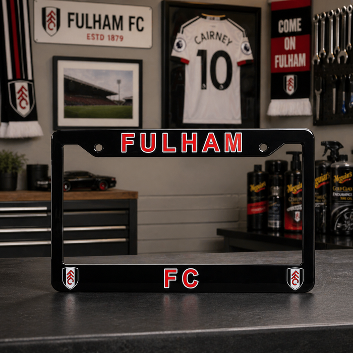 Fulham FC license plate frame on a counter with sports memorabilia in the background