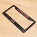 Black license plate frame with 'Liverpool FC' text on a wooden surface