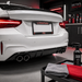 White car with a 'Liverpool FC' license plate in a detailing garage.