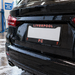 Black car with a Liverpool FC license plate in a car wash.