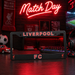 Liverpool FC license plate frame with neon sign in a sports-themed room