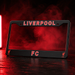 Black license plate frame with 'LIVERPOOL FC' text on a dark background with red smoke effect.