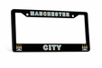 Black license plate frame with 'Manchester City' text on a white background