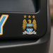 Man City FC logo on a black background