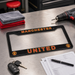 Manchester United license plate frame on a workbench with tools and documents.