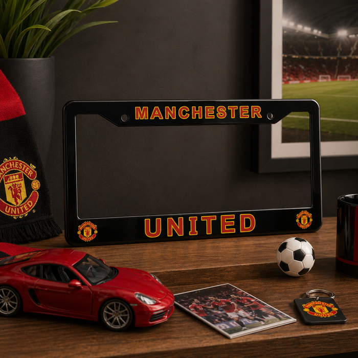 Manchester United license plate frame on a desk with sports-themed items