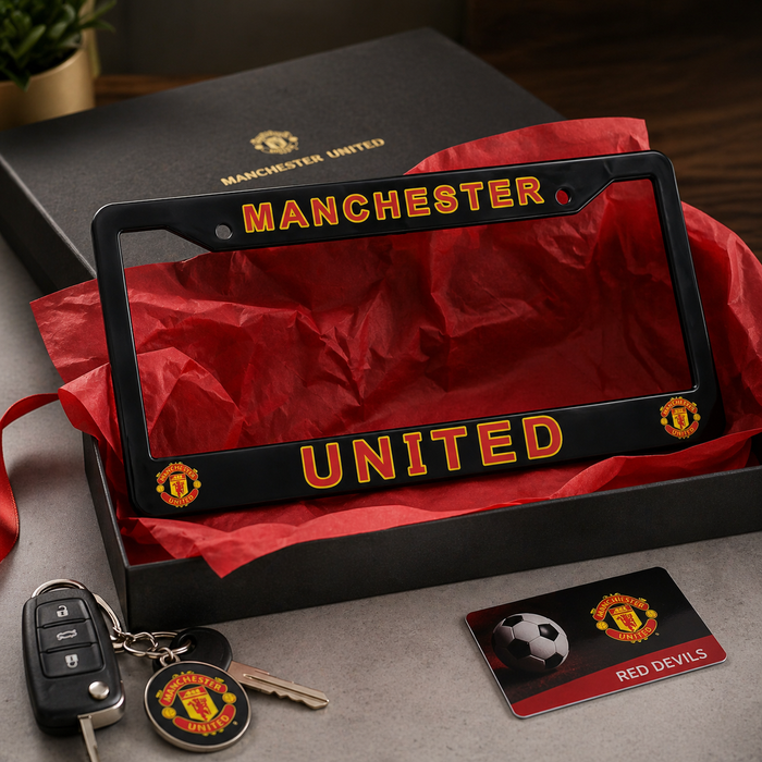 Manchester United license plate frame with car keys and card on a red fabric background