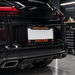 Black car with Manchester United license plate in a detailing studio