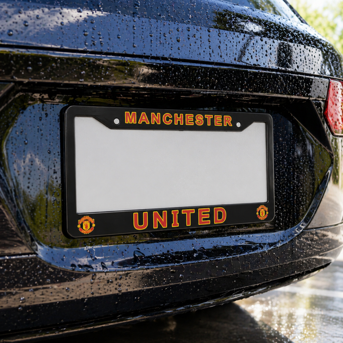 Black license plate frame with 'Manchester United' text on a car's rear