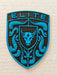 A porsche emblem with a bright blue and black design featuring the word 'ELITE' at the top, a bull head in the center, and crumrine designs around it, shown on a light textured fabric background.