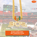A gold Miami Hurricanes 305 turnover chain necklace with a 'U' pendant embellished in orange and green, and '305' in rhinestones, shown against a blurred background of a football stadium.