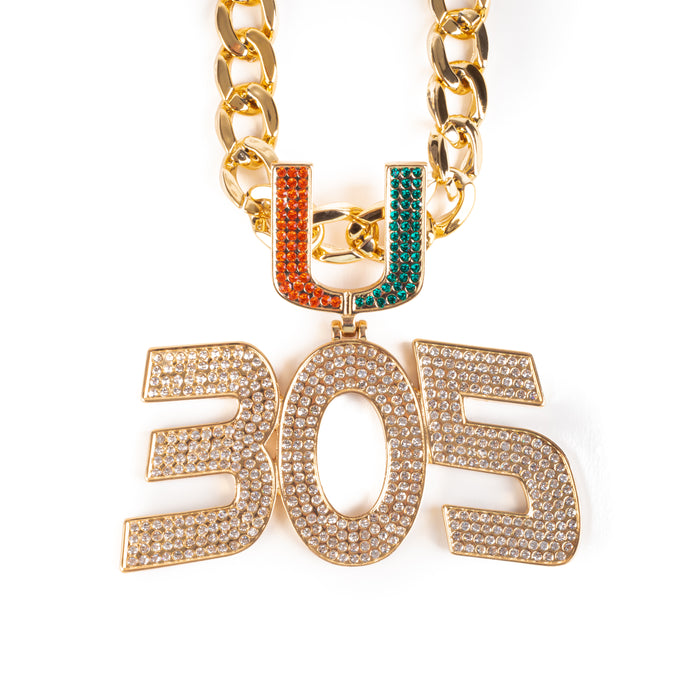 A gold-tone chain necklace featuring a large '305' pendant encrusted with clear rhinestones, and a 'U' charm split into an orange top half and a green bottom half, shown on a plain white background.