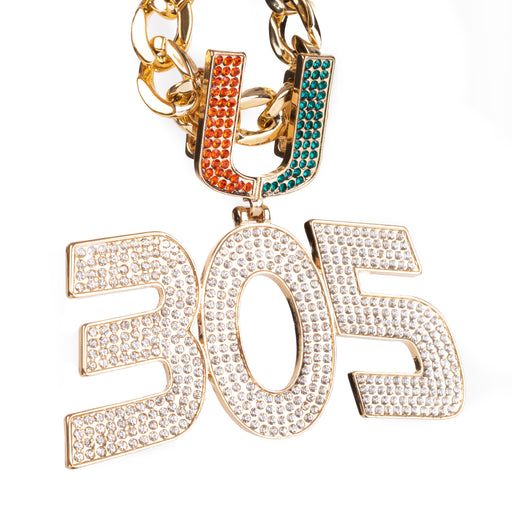 A gold-tone chain necklace featuring a large '305' pendant and a 'U' charm, both heavily embellished with clear rhinestones. The 'U' charm has one half in orange and the other in teal, while the '305' pendant is entirely clear rhinestone-covered.