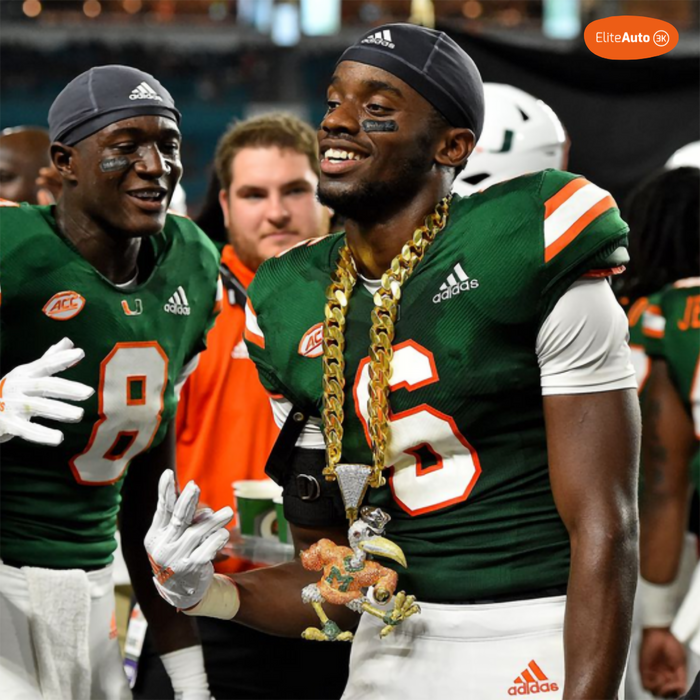 Two Miami Hurricanes football players in green jerseys celebrate on the field, with one wearing a large gold chain and a small alligator charm. Visible Adidas logos appear on the uniforms, and an ElnaAuto badge is in the top-right corner.